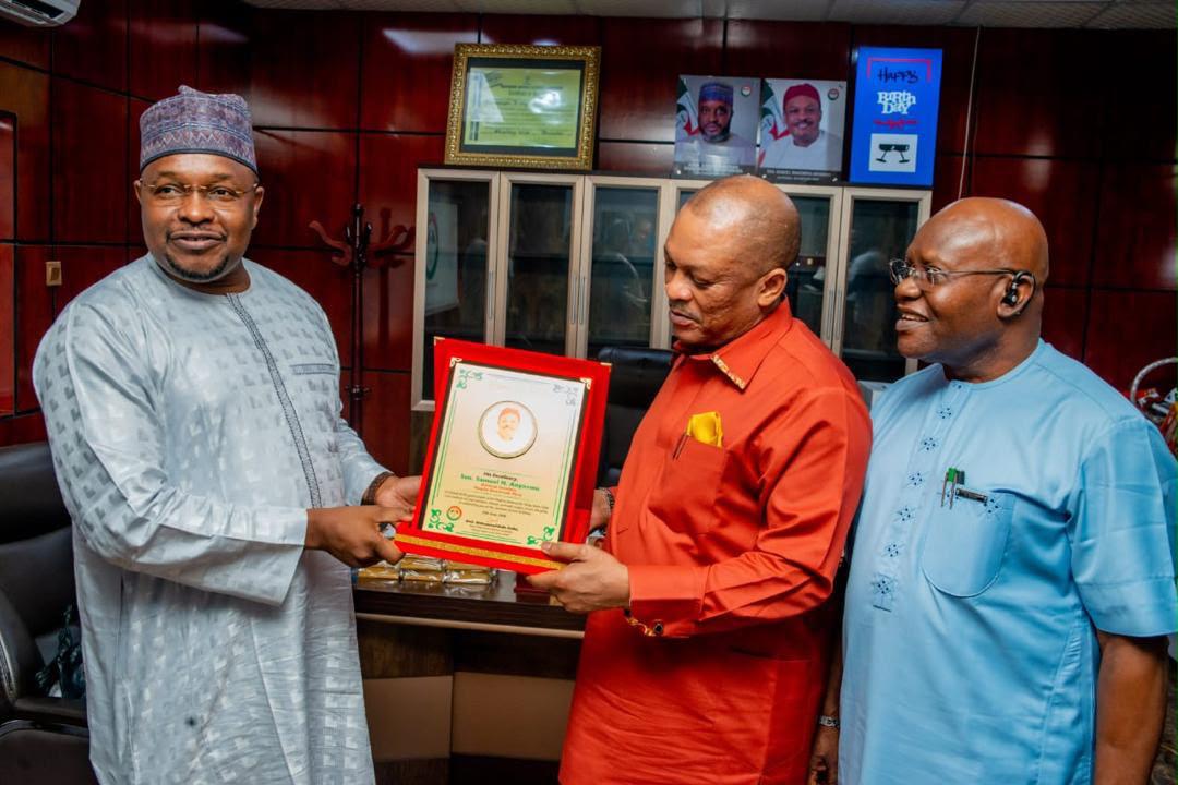 Amb. Muhammad Bello Dalha receiving a recognition plaque from party colleagues